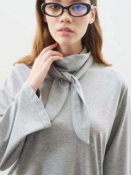 Manuka blouse with high collar and bow closure.