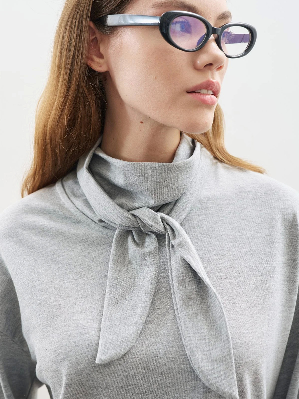 Manuka blouse with high collar and bow closure.