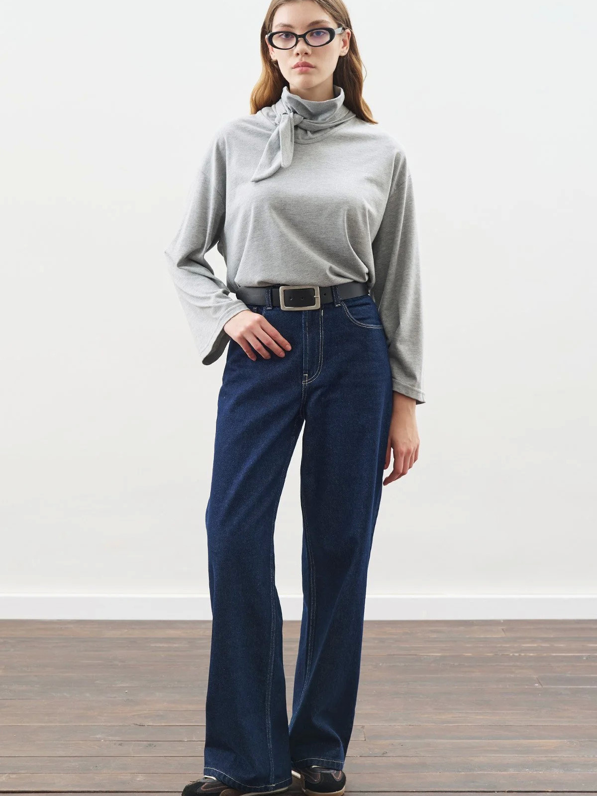 Manuka blouse with high collar and bow closure.